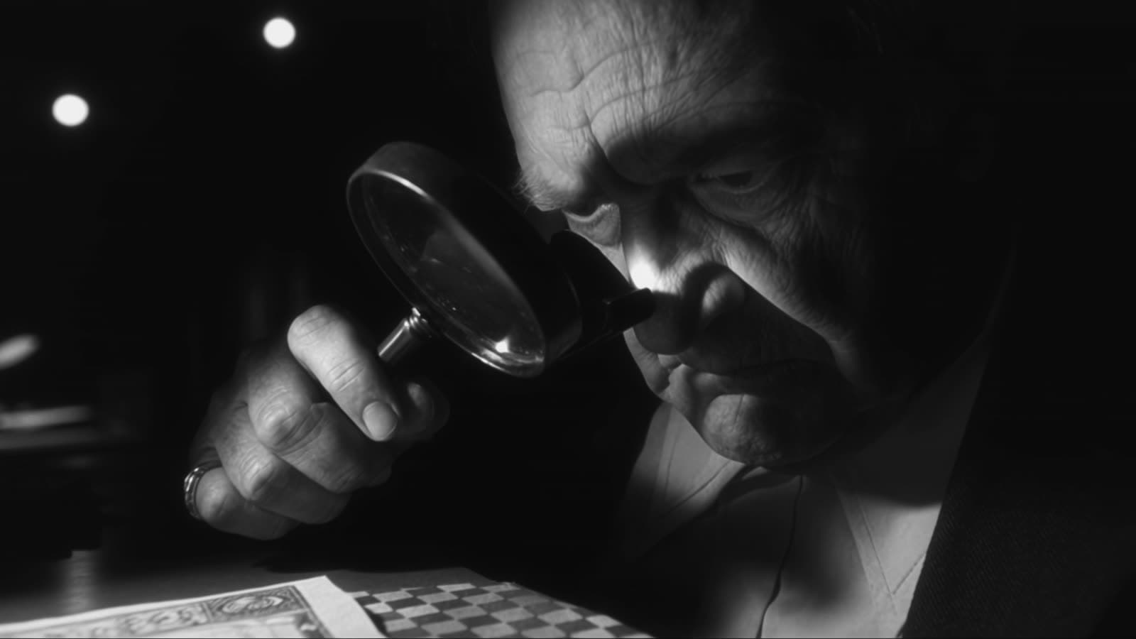 The appraiser examines a certificate through a loupe.